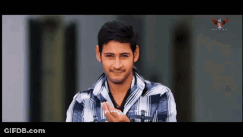 Man In Plaid Shirt Smiling In Front Of TV GIF