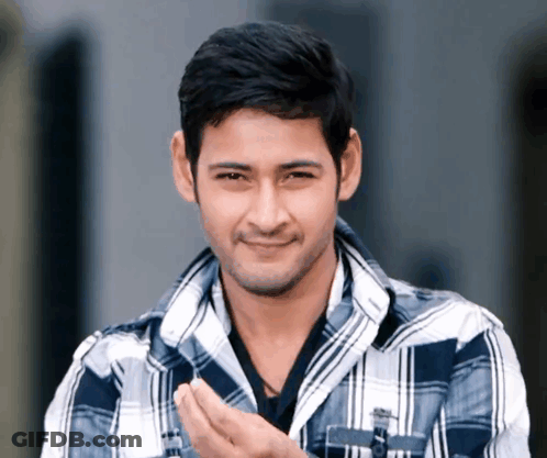 Man In Plaid Shirt Smiling With Hands Folded GIF