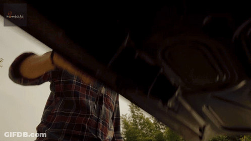 Man In Plaid Shirt Standing Before Nimble Sign GIF