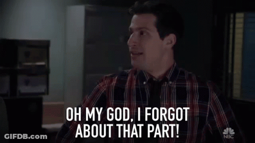 Man In Plaid Shirt Standing In Dark Room GIF