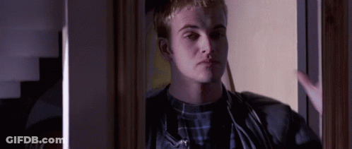 Man In Plaid Shirt Standing In Doorway GIF