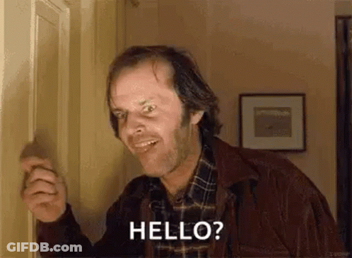 Man In Plaid Shirt Standing In Front Of Door GIF