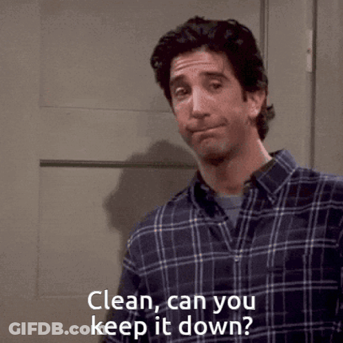 Man In Plaid Shirt Standing In Front Of Door GIF