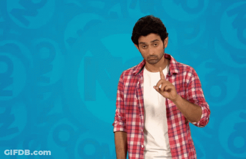 Man In Plaid Shirt Standing In Front Of Maaf Kar Bhai Sign GIF