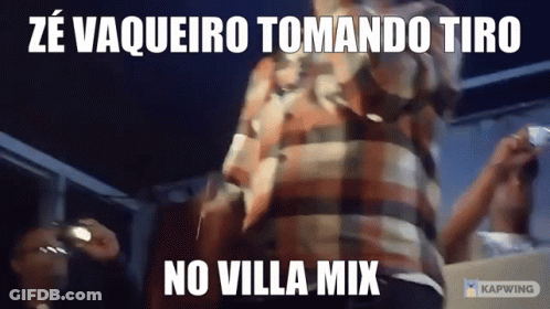 Man In Plaid Shirt Standing In Front Of No Villa Mix Sign GIF