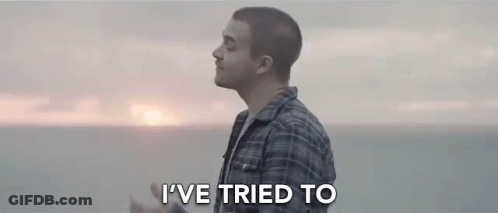 Man In Plaid Shirt Standing In Front Of Ocean GIF