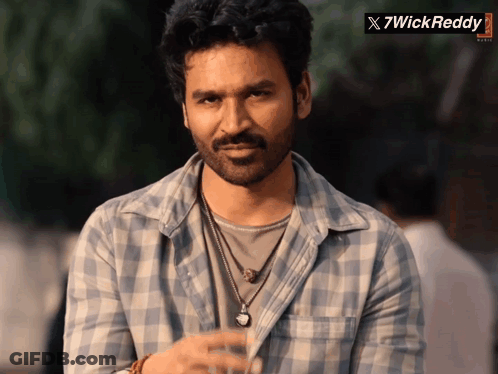 Man In Plaid Shirt Standing In Front Of X7wickreddy Banner GIF