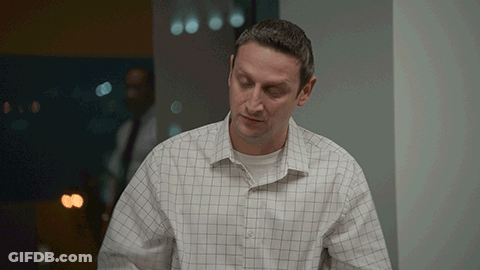 Man In Plaid Shirt Standing In Room GIF