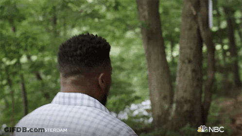 Man In Plaid Shirt Standing In Woods With NBC Logo GIF