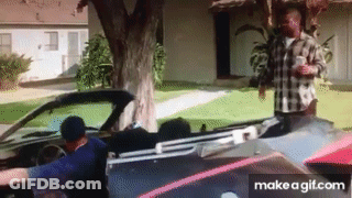 Man In Plaid Shirt Standing Next To Man In Car GIF