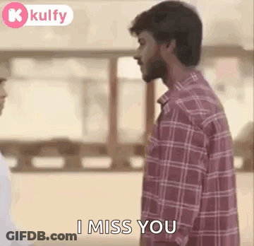 Man In Plaid Shirt Standing Next To Man In White Shirt GIF