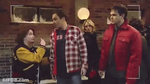 Man In Plaid Shirt Talking On Phone Woman In Yellow Jacket GIF