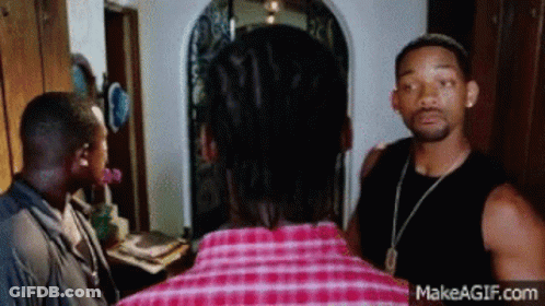 Man In Plaid Shirt Talking To Another Man GIF
