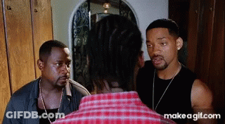 Man In Plaid Shirt Talking To Another Man GIF
