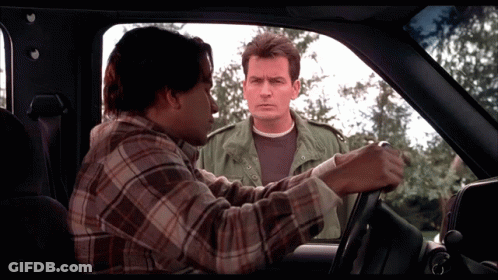 Man In Plaid Shirt Talking To Another Man In Car GIF