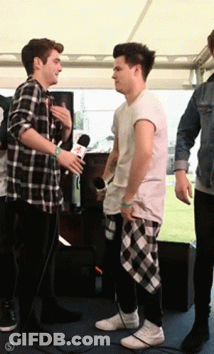 Man In Plaid Shirt Talking To Another Man GIF