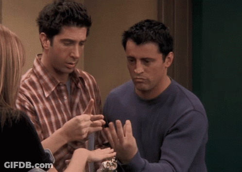 Man In Plaid Shirt Talking To Man In Blue Shirt GIF