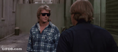 Man In Plaid Shirt Talks To Man In Blue Shirt GIF
