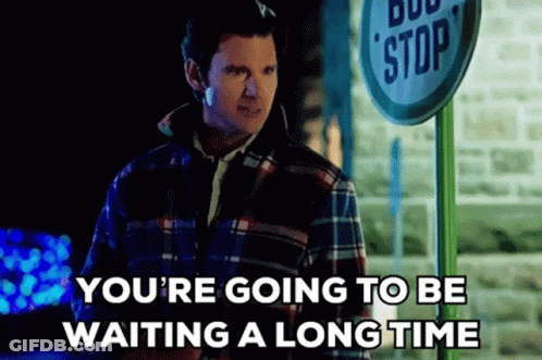 Man In Plaid Shirt Waiting At Bus Stop GIF