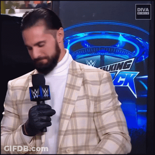 Man In Plaid Shirt With Button Saying II GIF