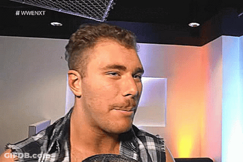 Man In Plaid Shirt With Microphone In Mouth GIF
