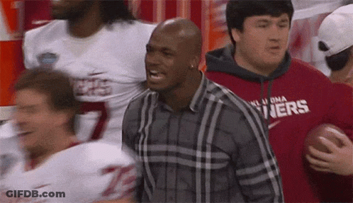 Man In Plaid Shirt With Oklahoma Holding Football GIF