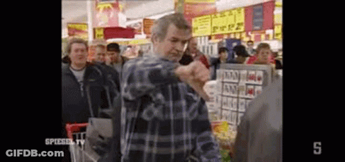 Man In Plaid Shirt With Shopping Cart In Crowded Grocery Store GIF