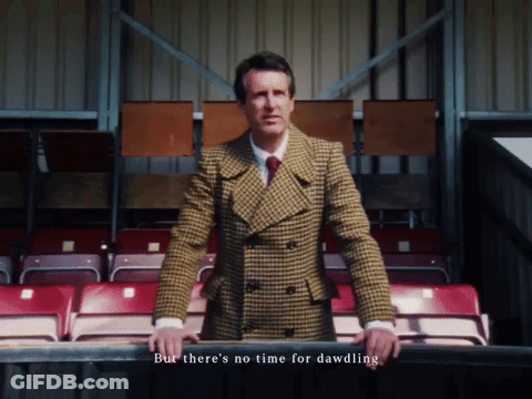 Man In Plaid Suit In Stadium But There's No Time For Dawdling GIF