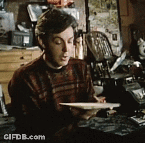 Man In Plaid Sweater Reading Book GIF