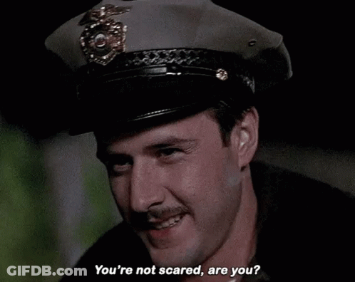 Man In Police Hat Asking If Not Scared GIF
