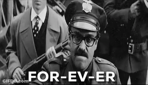 Man In Police Uniform Holding Gun GIF