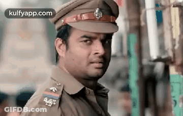 Man In Police Uniform Looking At Camera GIF