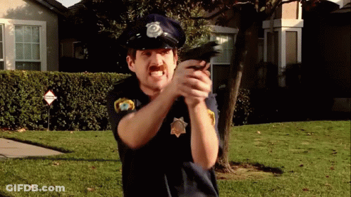 Man In Police Uniform Pointing Gun GIF