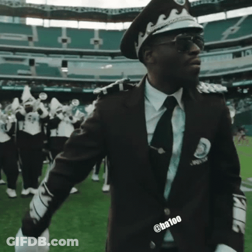 Man In Police Uniform Saluting In Stadium GIF