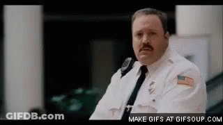 Man In Police Uniform Sitting In Room GIF
