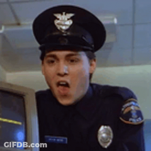 Man In Police Uniform Standing In Front Of Computer Monitor GIF