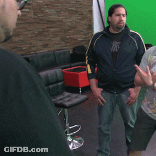 Man In Polka Dot Shirt And Tie Holding Hula Hoop GIF