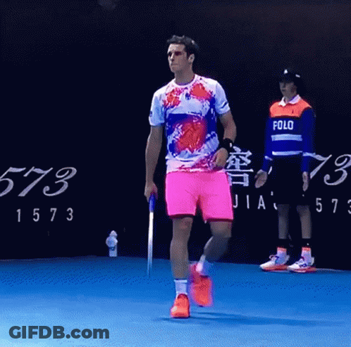 Man In Polo Shirt Walking On Blue Court GIF