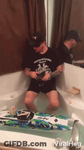 Man In Prestige Worldwide Shirt Sitting In Bathtub GIF