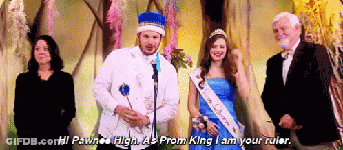 Man In Prom King Costume Next To Woman In Blue Dress And Suit GIF