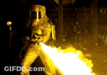 Man In Protective Suit Spraying Fire GIF