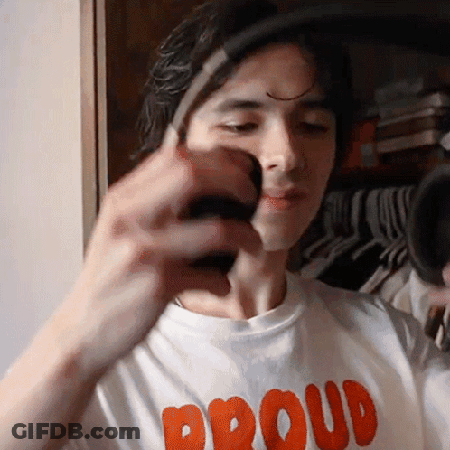 Man In Proud Shirt Holding Something GIF