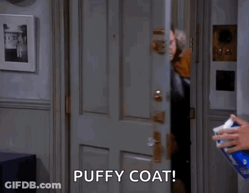 Man In Puffy Coat Standing In Doorway With Tissues GIF