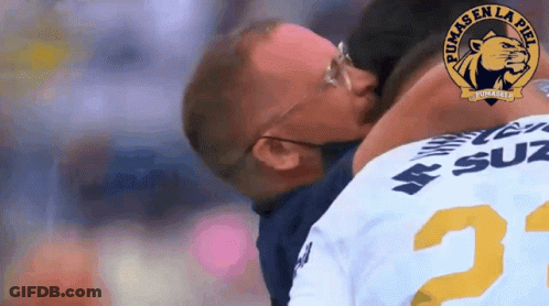 Man In Pumas Jersey Kissing Another GIF