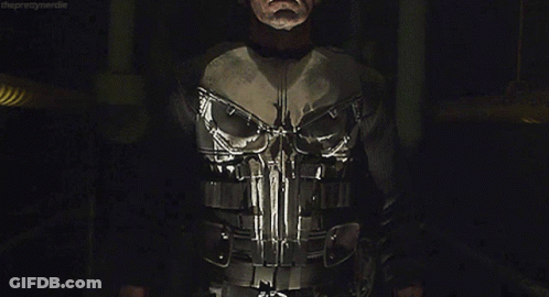 Man In Punisher Costume In Dark Room GIF