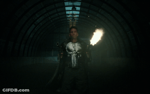 Man In Punisher Shirt Holding Guns GIF