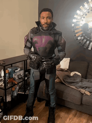 Man In Purple And Black Suit Facing Mirror GIF