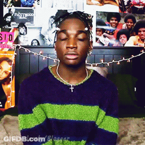 Man In Purple And Green Striped Sweater Cross GIF