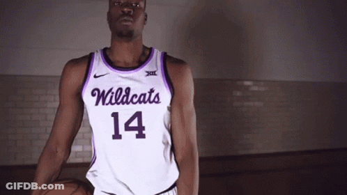 Man In Purple And White Wildcats Jersey Holding Basketball GIF