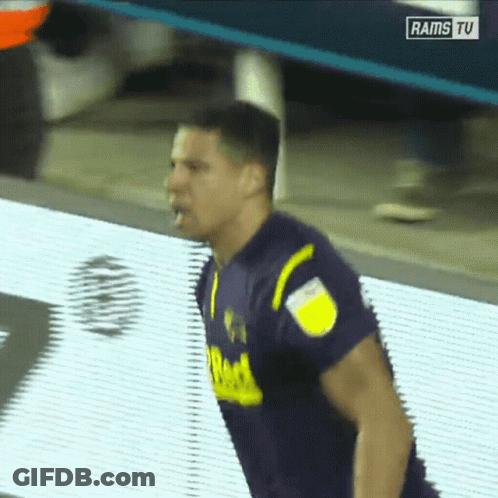Man In Purple And Yellow Jersey On Rams TV Screen GIF